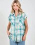 Woman wearing a plaid shirt with short sleeves on a plain background