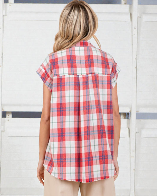 Woman wearing a red and white plaid shirt against a white background