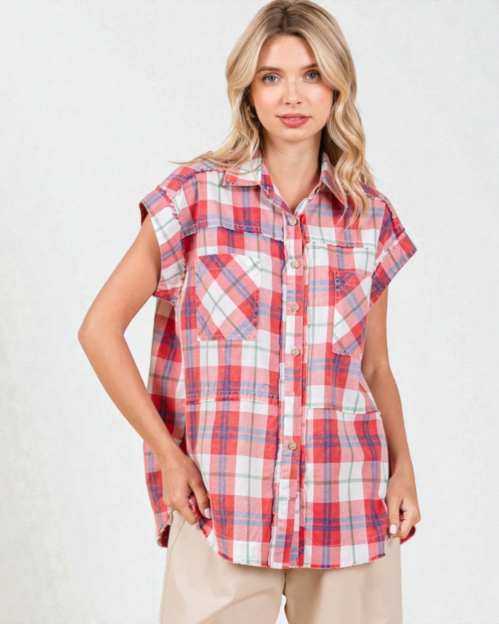 Woman wearing a red and white plaid shirt on a plain background