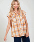 Woman wearing an orange and blue plaid sleeveless shirt against a plain background