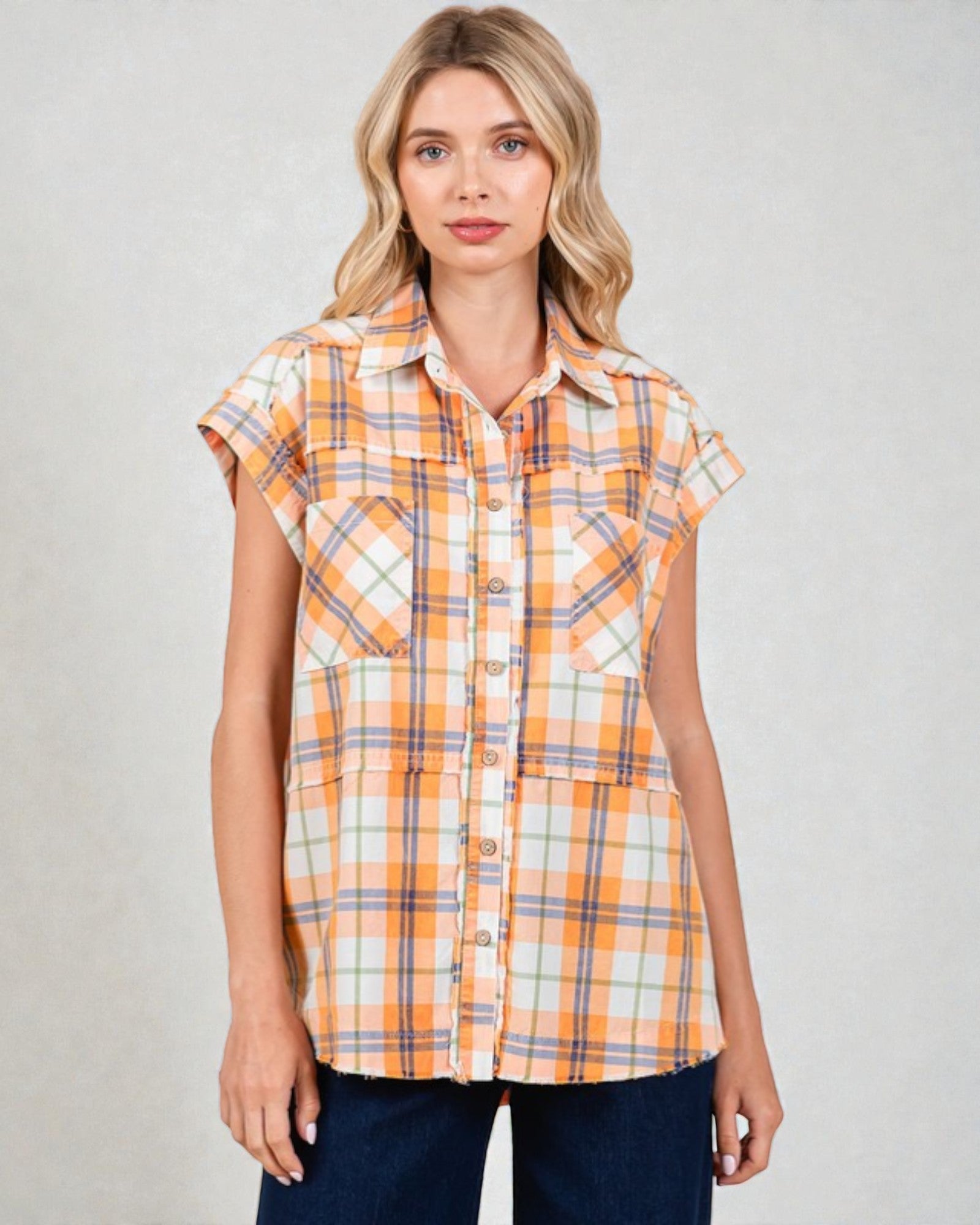 Woman wearing a plaid shirt with a neutral background