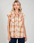 Woman wearing a plaid shirt with a neutral background