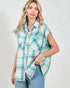 Woman wearing a plaid shirt with short sleeves on a plain background
