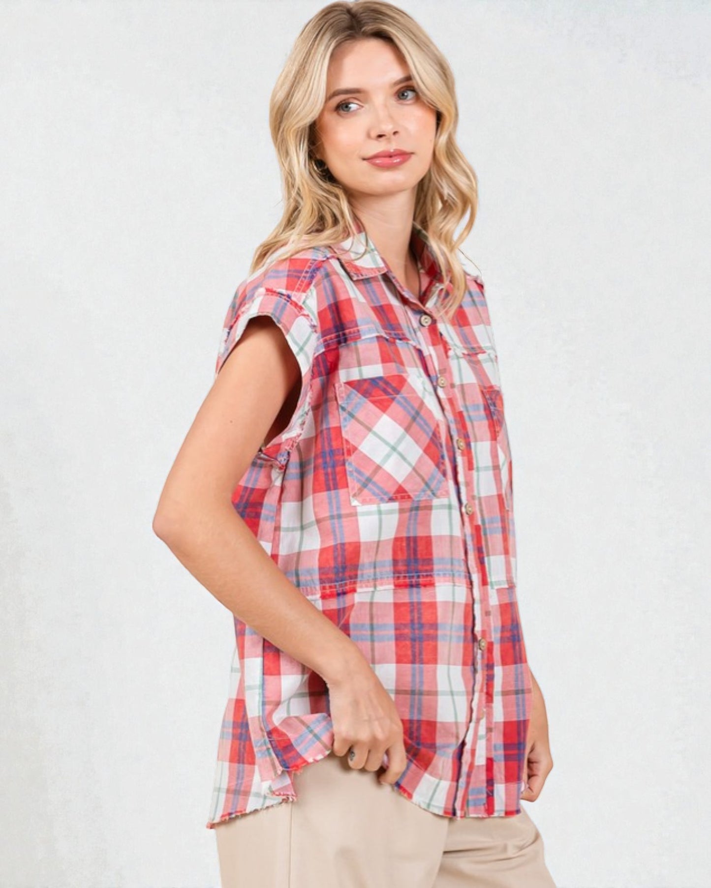 Woman wearing a red and white plaid shirt on a white background
