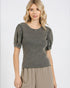 Woman wearing a gray top with puff sleeves on a white background