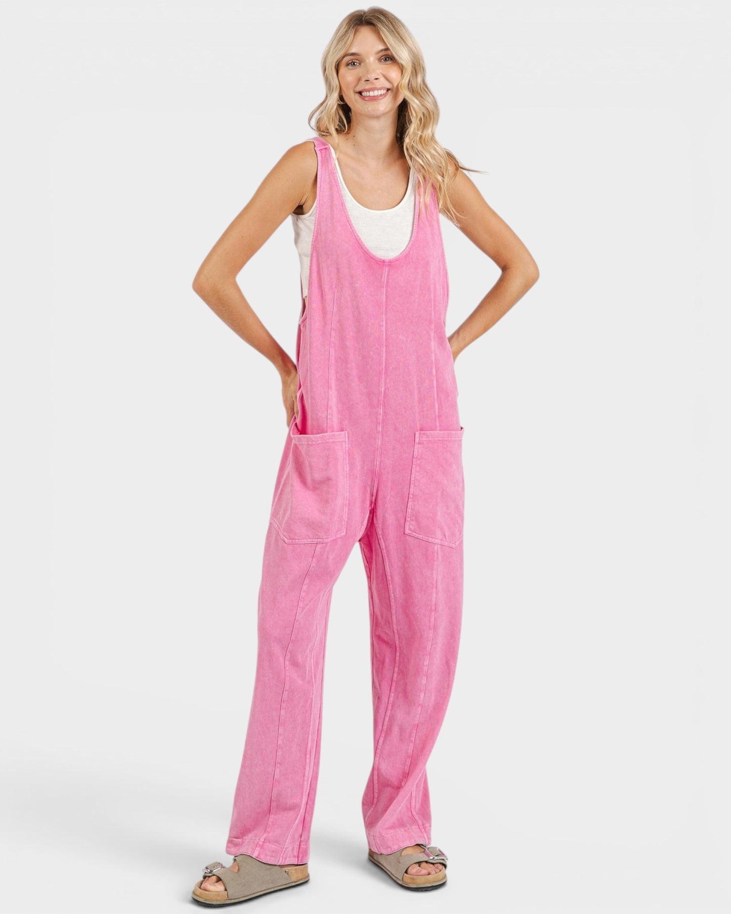 Woman wearing a pink overalls on a white background
