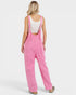 Person wearing pink overalls on a white background
