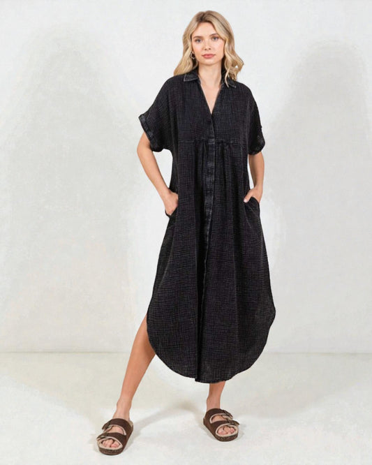 Woman wearing a black dress with short sleeves on a white background