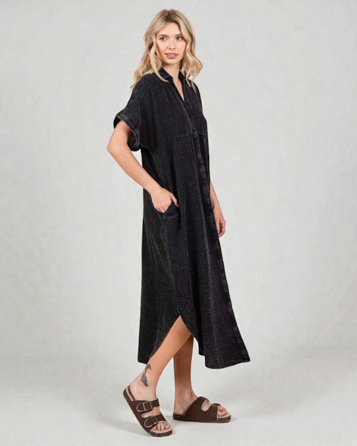 Woman wearing a black dress with a plain background