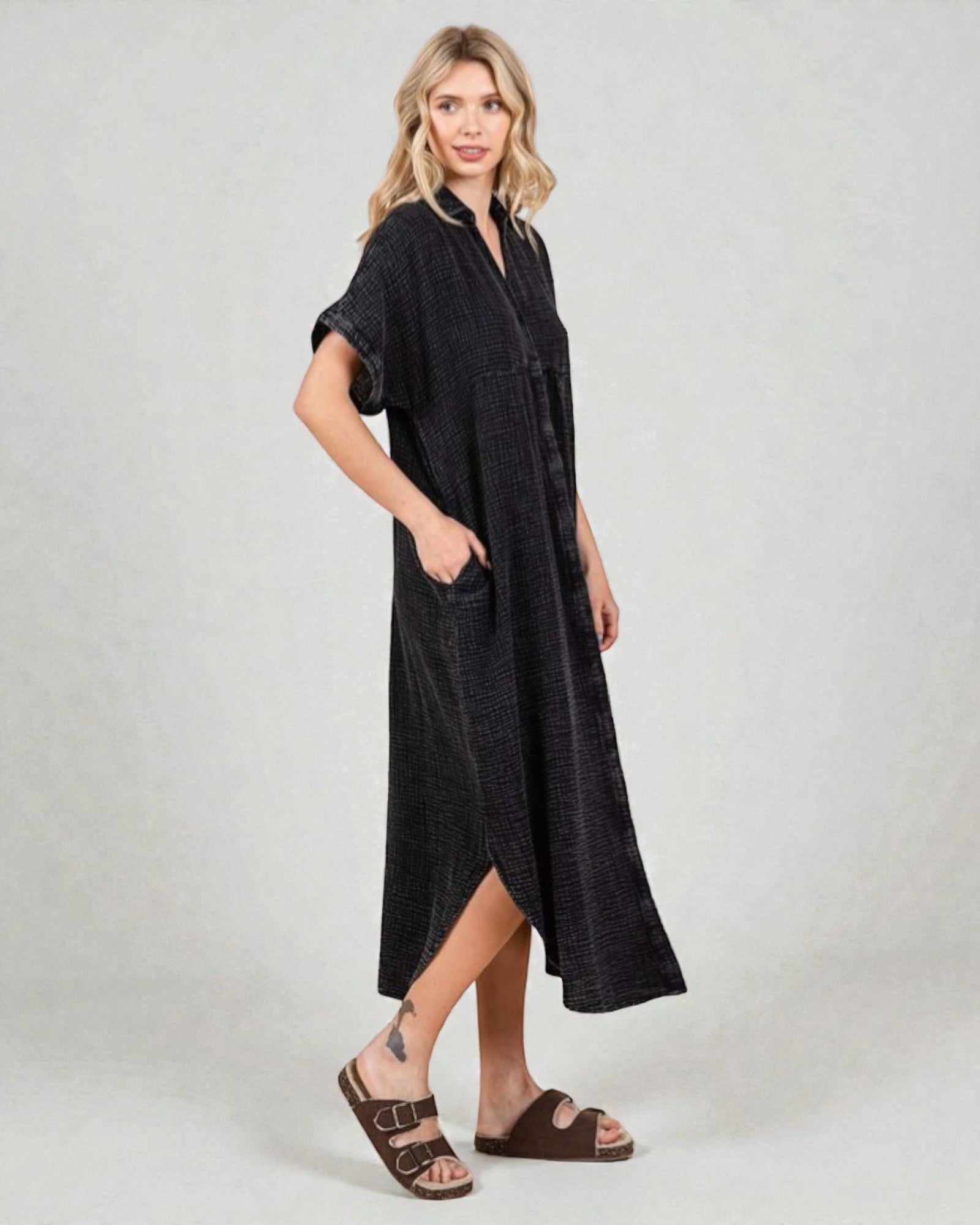 Woman wearing a black dress with a plain background