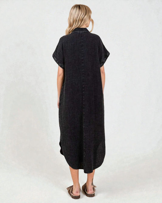 Woman wearing a black dress with short sleeves on a white background