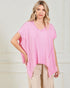 Woman wearing a pink poncho against a white background