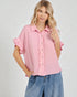 Woman wearing a pink checkered blouse with ruffled sleeves on a white background