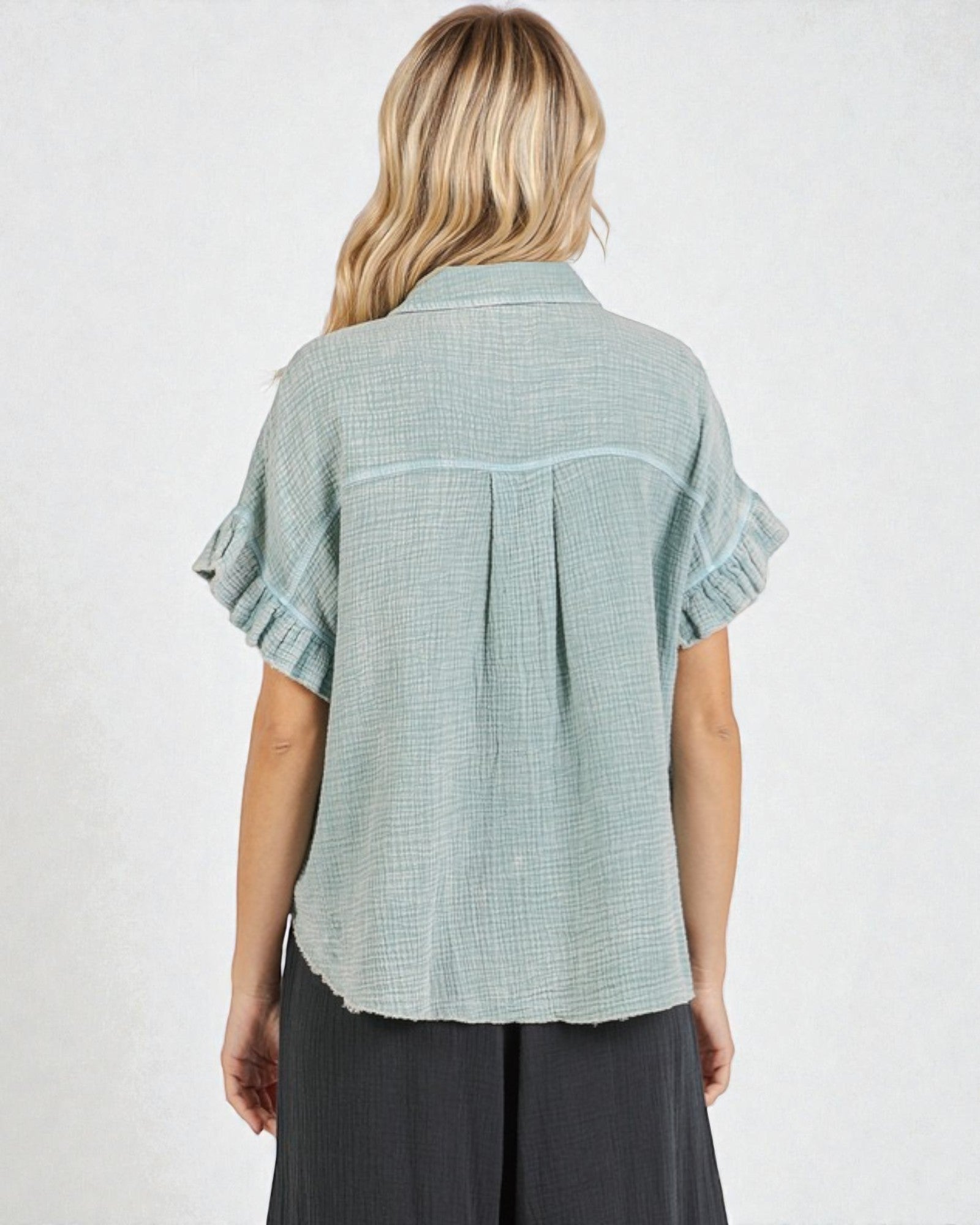 Woman wearing a light green checkered shirt on a white background