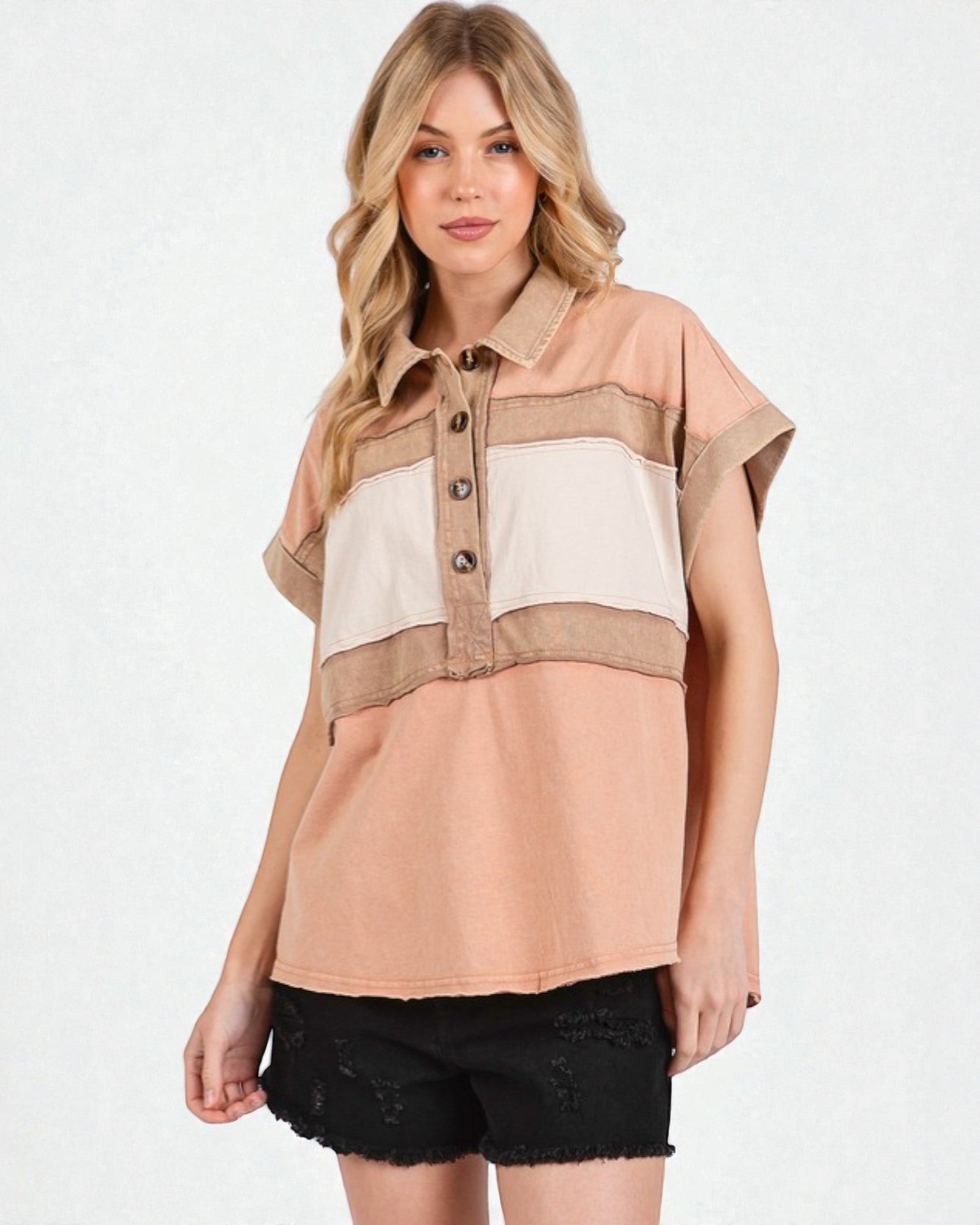 Woman wearing a beige and brown color-blocked shirt on a white background