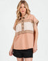 Woman wearing a beige and brown color-blocked shirt on a white background