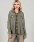 Woman wearing a green jacket with button details on a plain background