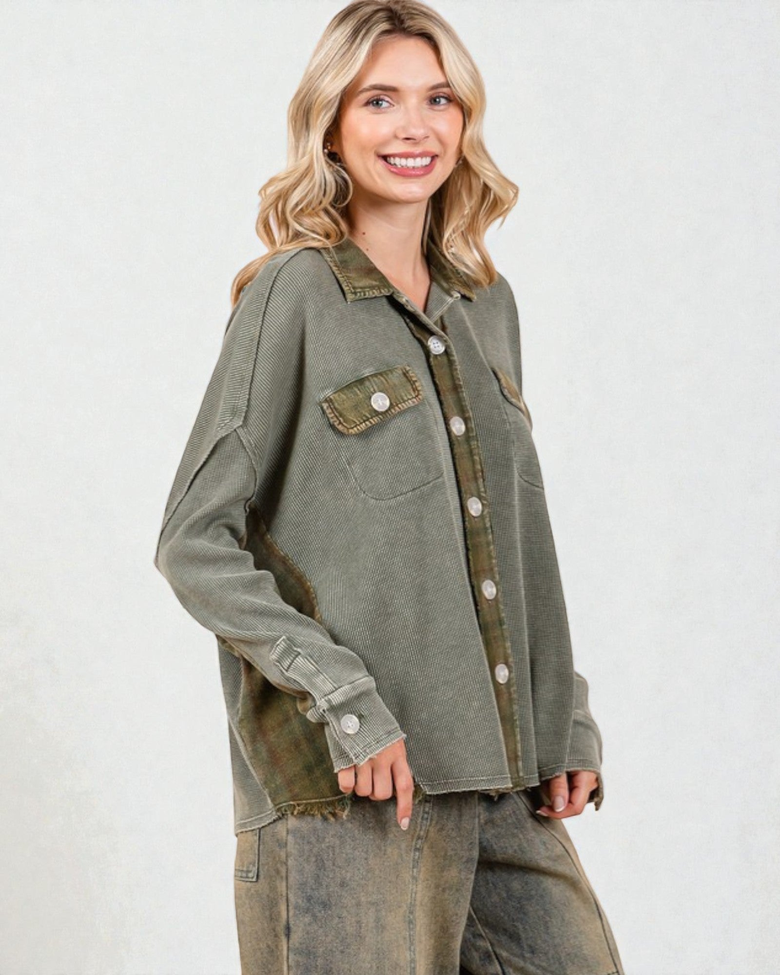 Woman wearing a green jacket with a white background