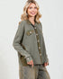 Woman wearing a green jacket with a white background