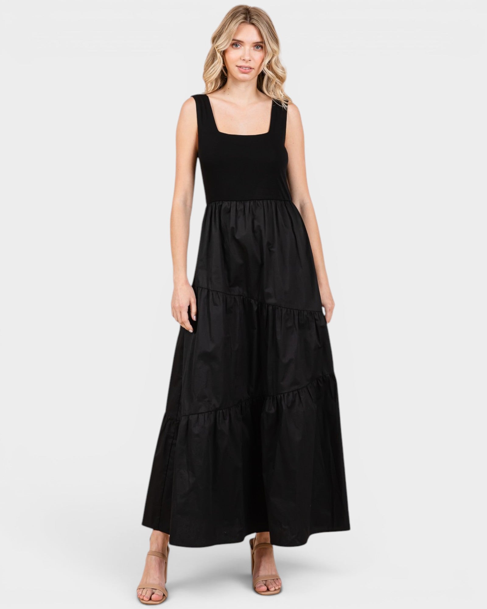 Woman wearing a black sleeveless dress on a white background