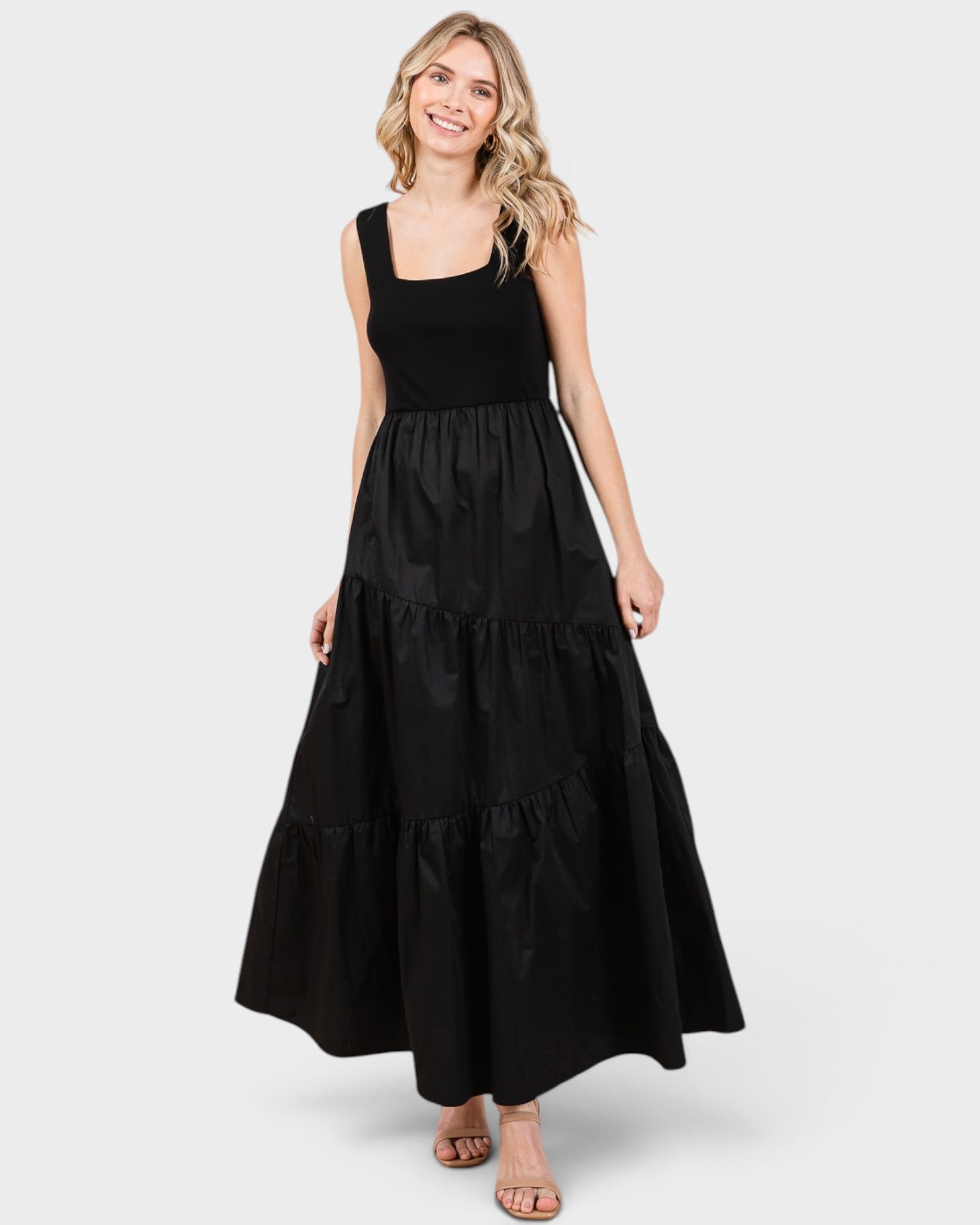 Woman wearing a black sleeveless dress on a white background
