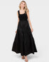Woman wearing a black sleeveless dress on a white background