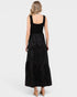 Woman wearing a black tiered dress on a white background