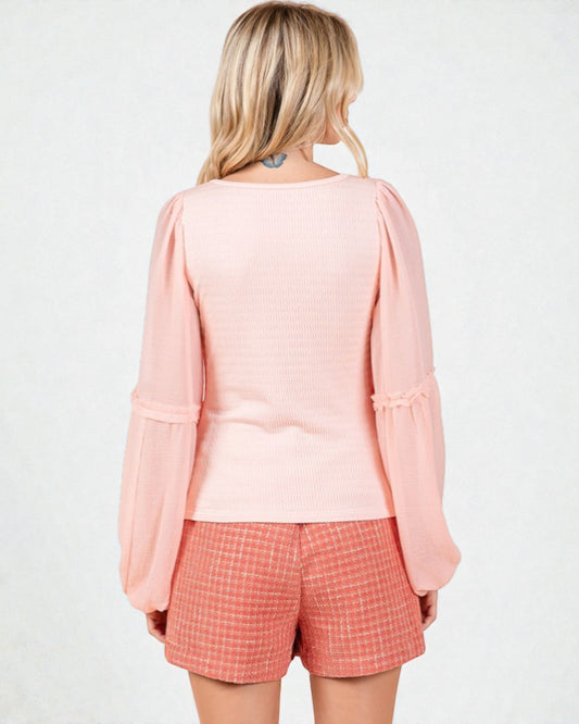 Woman wearing a pink top and checkered shorts on a white background