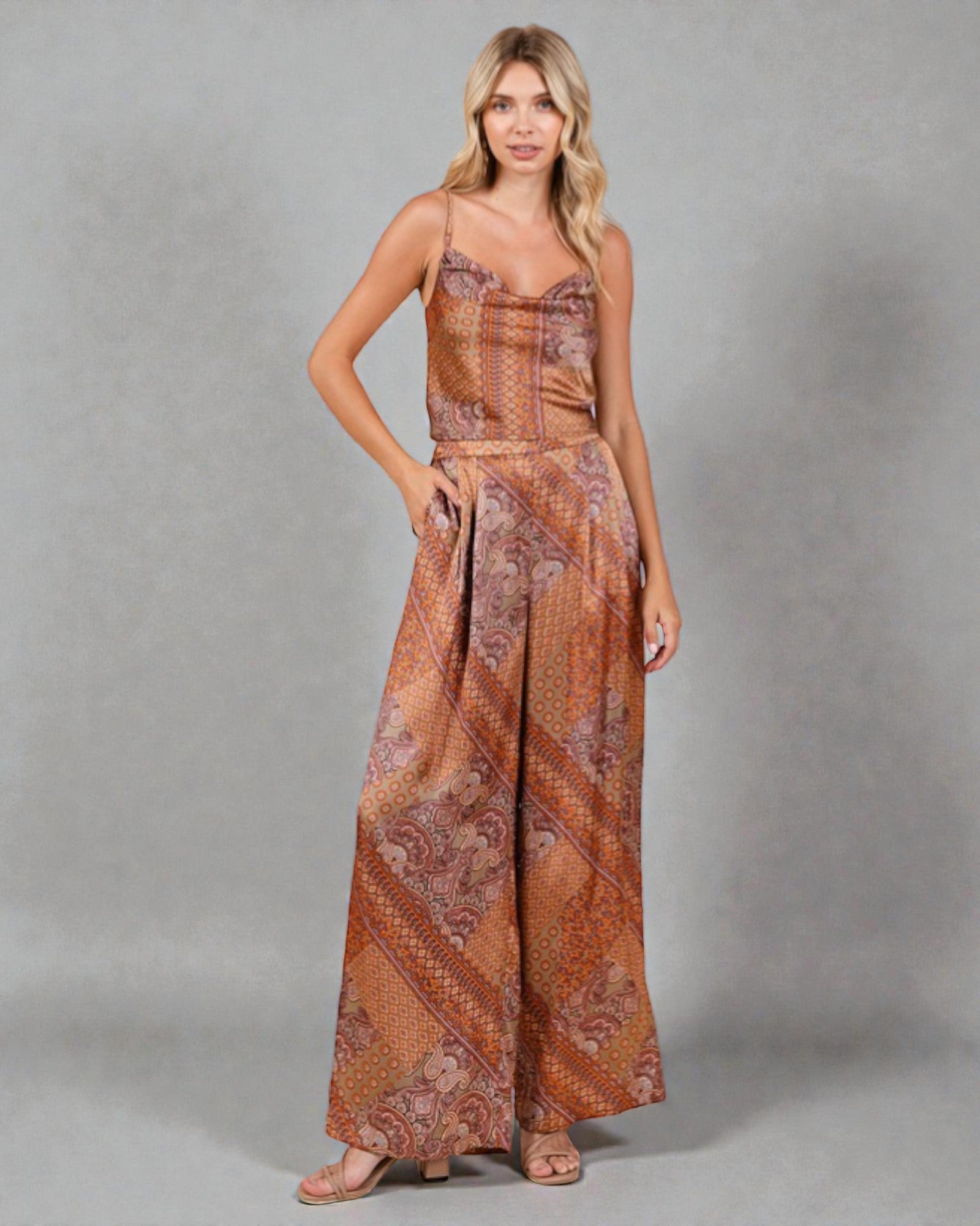 Woman wearing a patterned dress against a gray background