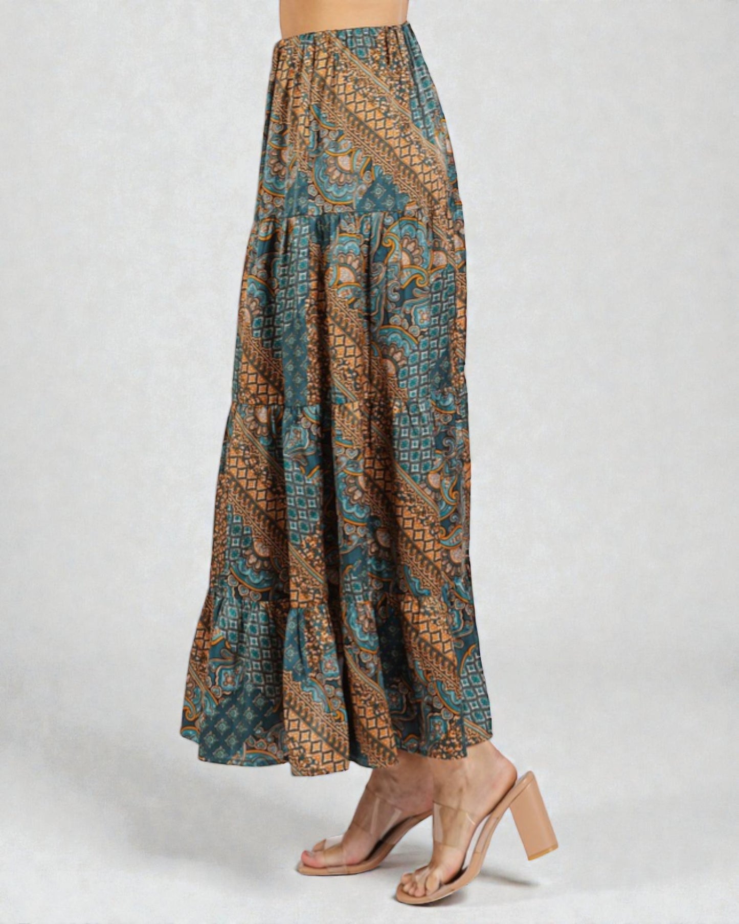 Long patterned skirt worn by a person on a white background