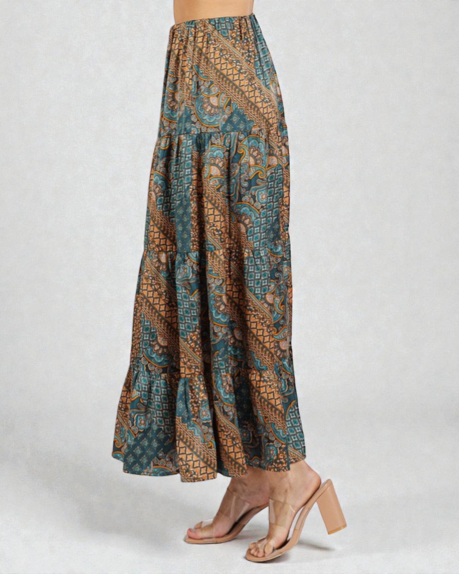 Long patterned skirt worn by a person on a white background