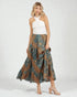 Woman wearing a white top and patterned skirt on a white background