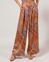 Patterned pants worn by a person on a plain background