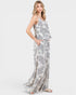 Woman wearing a floral jumpsuit on a white background