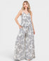 Woman wearing a gray and white patterned jumpsuit on a white background