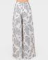 White pants with gray paisley pattern on a white background