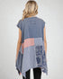 Woman wearing a sleeveless, patchwork-style top with a white background