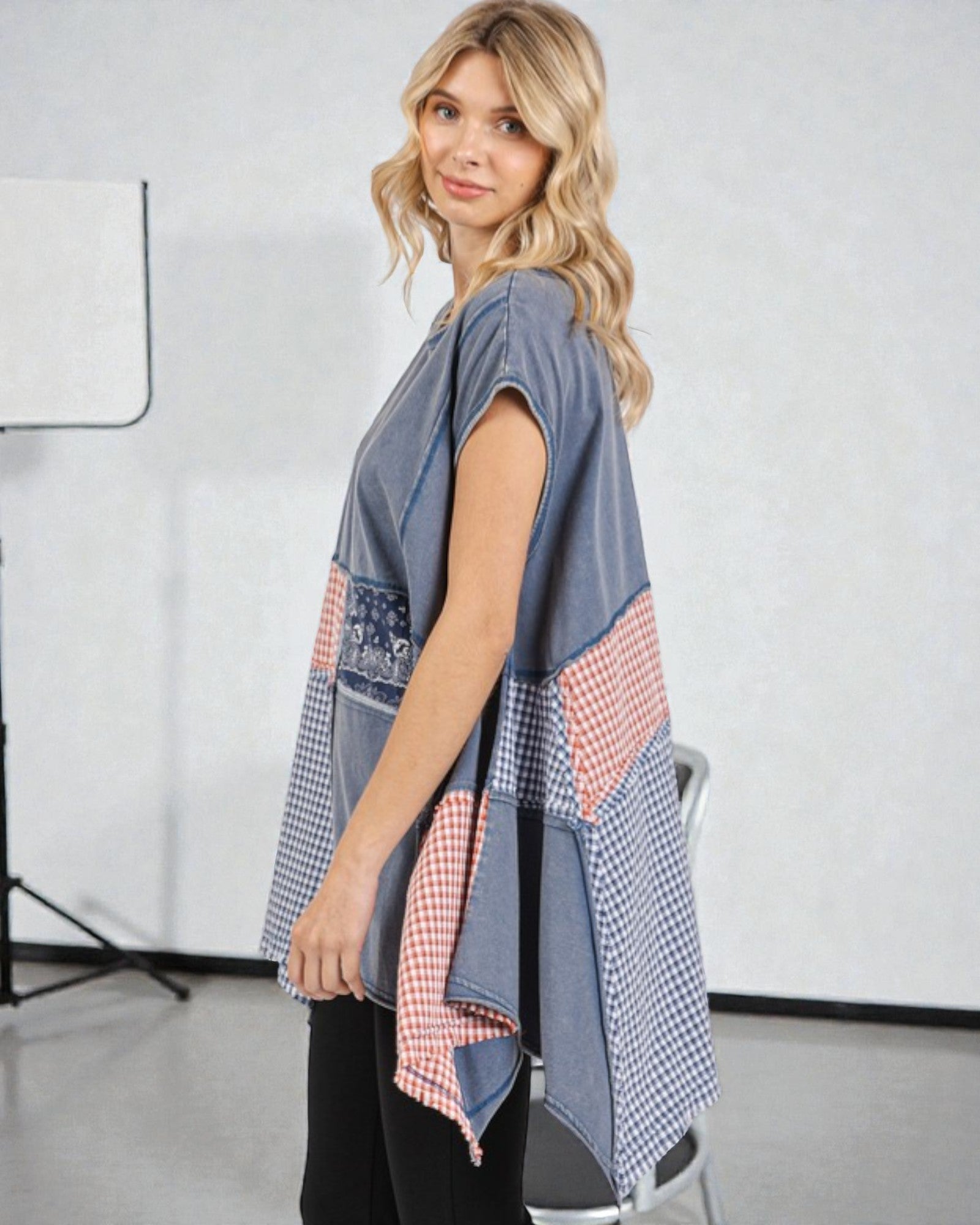 Woman wearing a patchwork dress in a studio setting