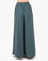 A pair of wide-leg trousers in a muted teal blue-green color, shown on a model from the waist down against a plain white background.