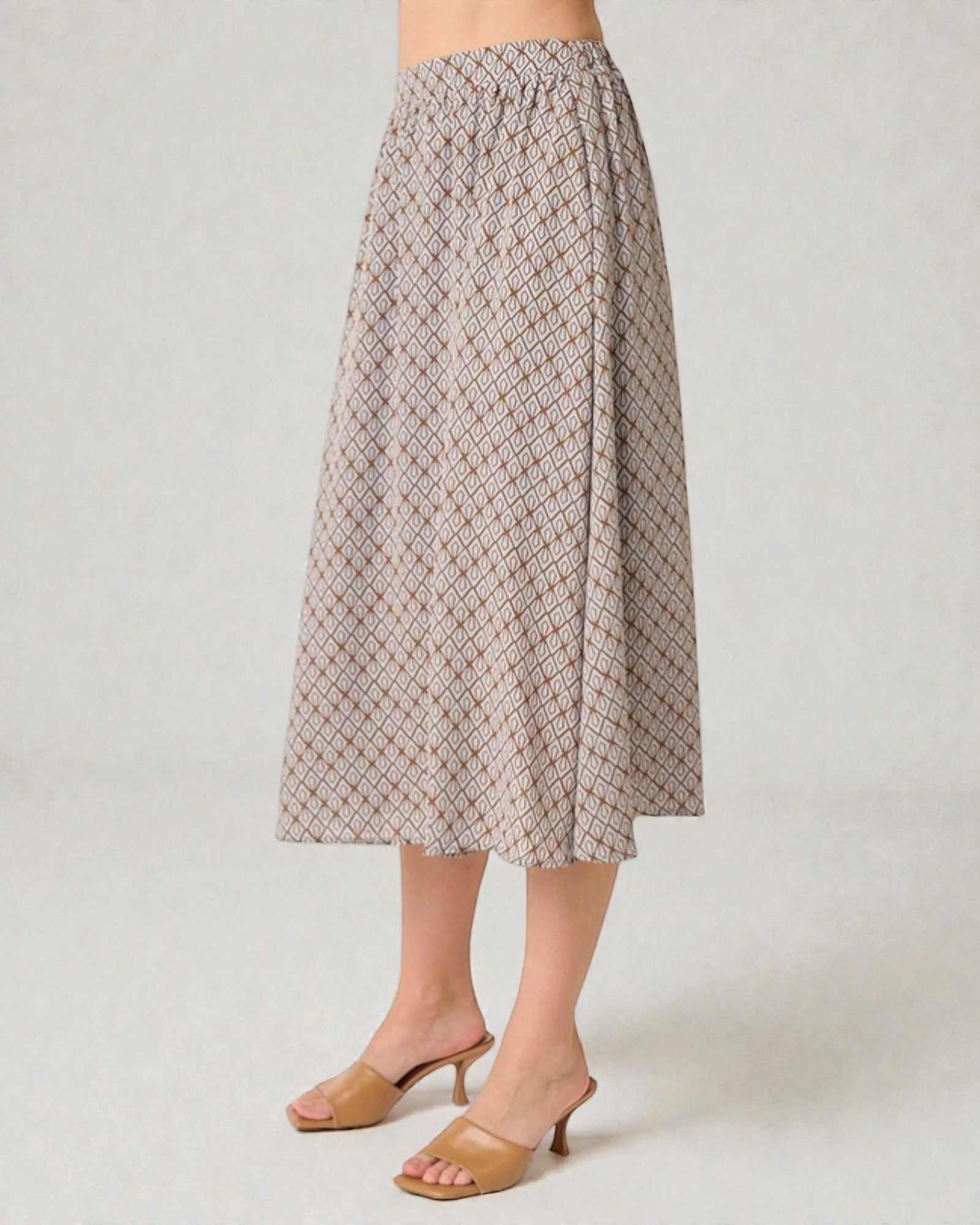 Patterned skirt worn by a person on a plain background