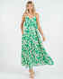 Woman wearing a green and white floral dress on a white background