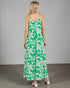 Woman wearing a green and white leaf-patterned dress against a gray background