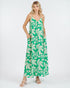 Woman wearing a green and white leaf-patterned dress on a white background