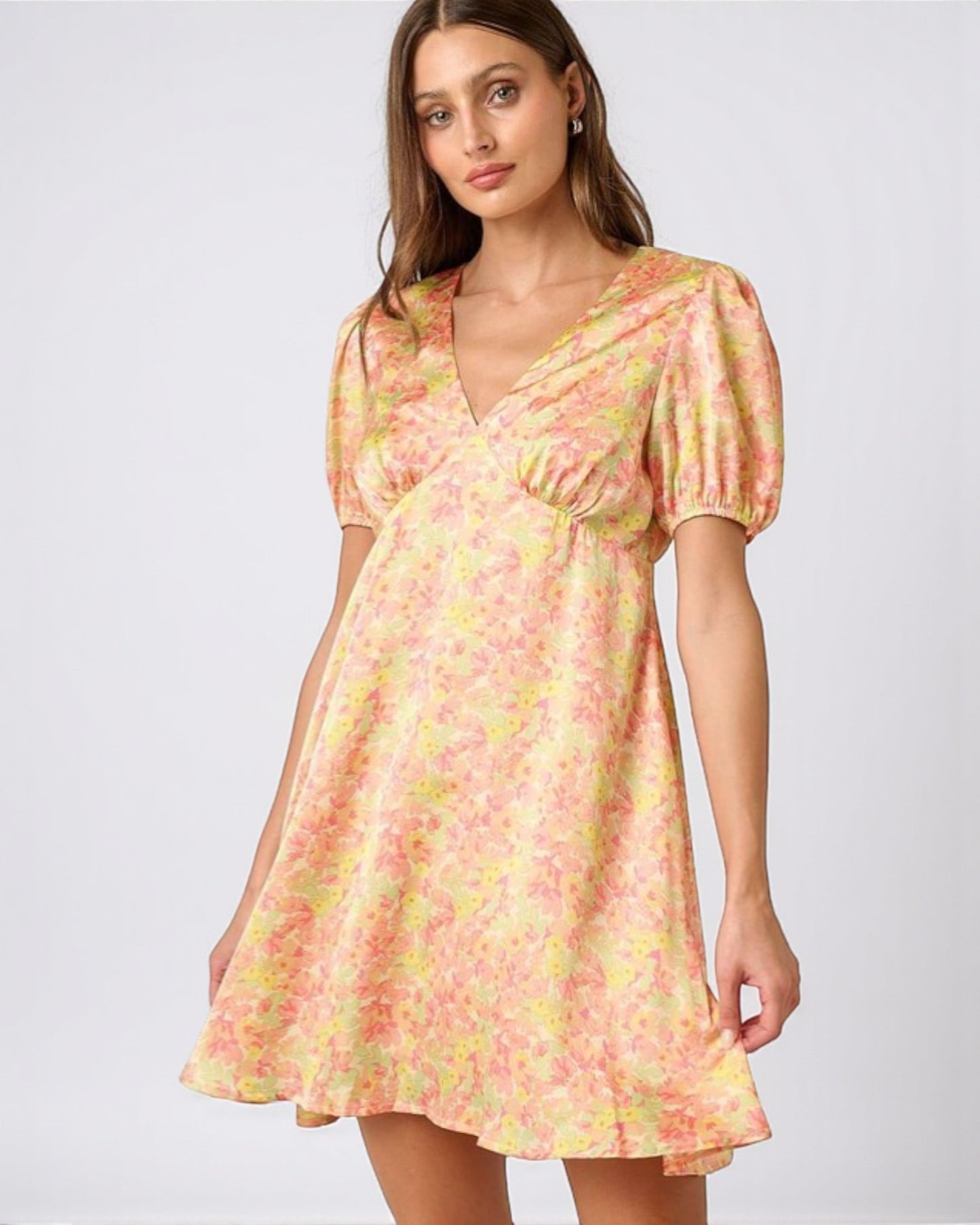 Woman wearing a floral dress on a white background