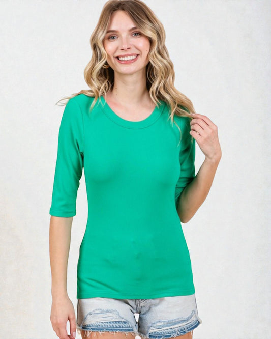 Woman wearing a green t-shirt and denim shorts on a white background