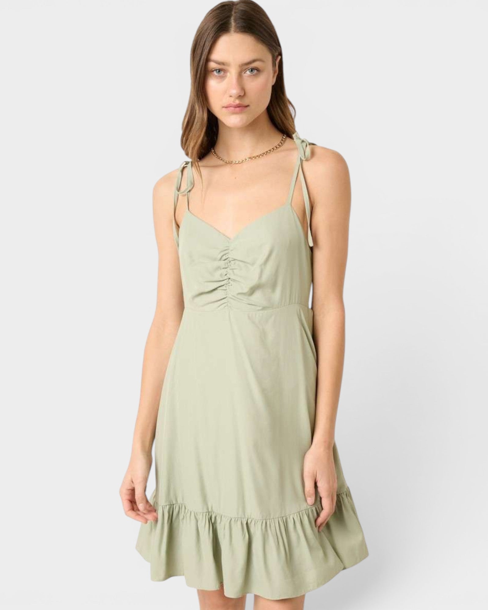 Woman wearing a light green dress on a white background
