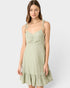Woman wearing a light green dress on a white background
