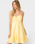 Woman wearing a yellow dress on a white background