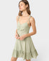 Woman wearing a light green dress on a white background