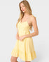 Woman wearing a yellow dress against a white background